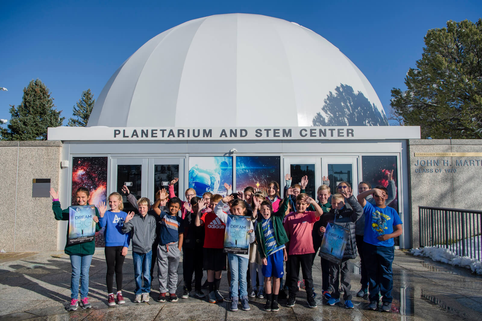 Students from St. Paul Catholic School in Colorado Springs wave for the camera following the planetarium’s “Dream Big: Engineering our World” show at the Air Force Academy, Colo., Oct. 25, 2019. The school’s STEM teacher said the experience was incredible and inspiring and the new multimedia capabilities of the planetarium captivated him and the students. (U.S. Air Force photo by Trang Le)
