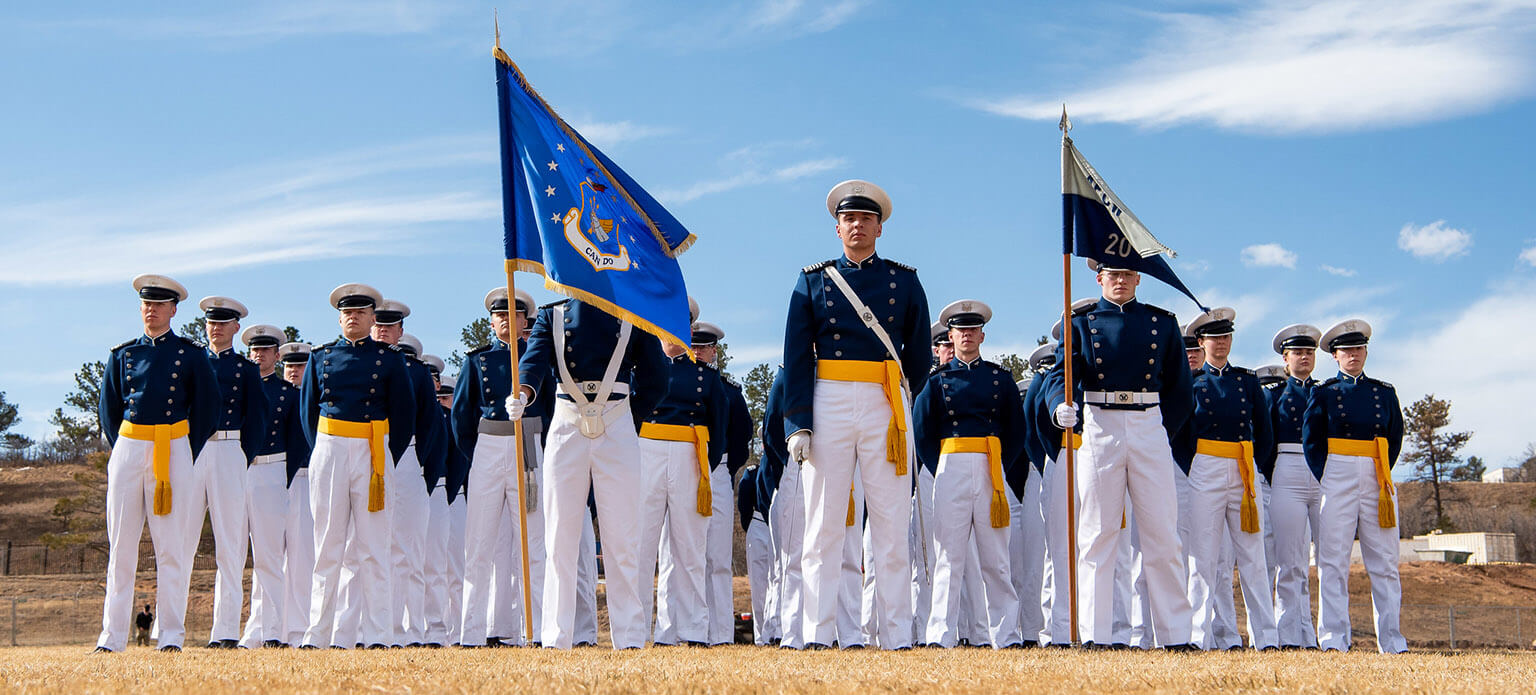 Cadets in dress uniform in formation.