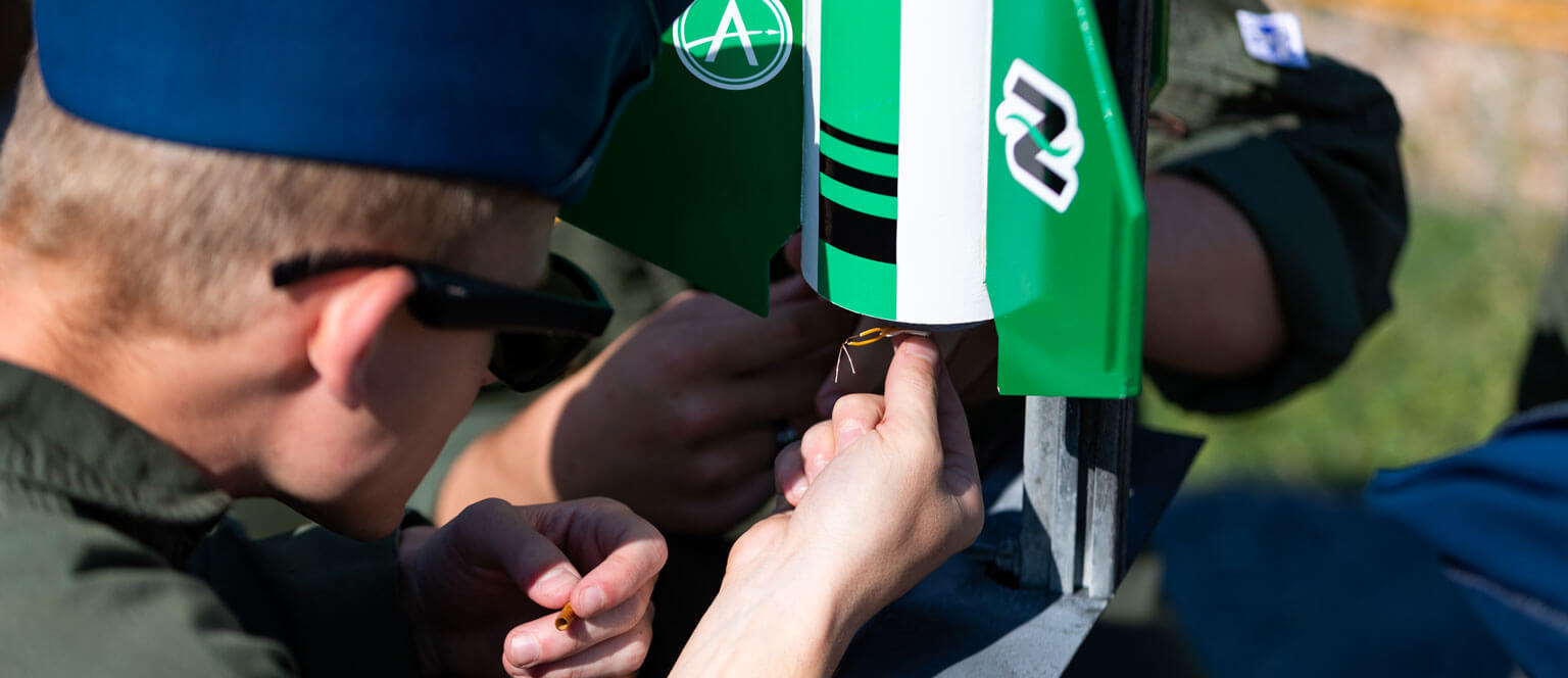 A Cadet working on a rocket in the Blue Horizons Rocketry Club.