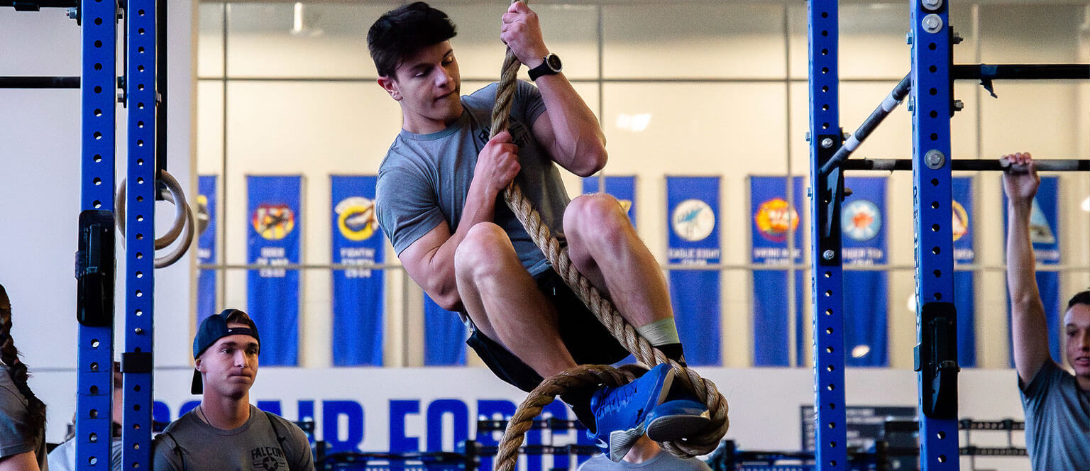 A cadet in a rope climbing exercise for the Falcon CrossFit Club.