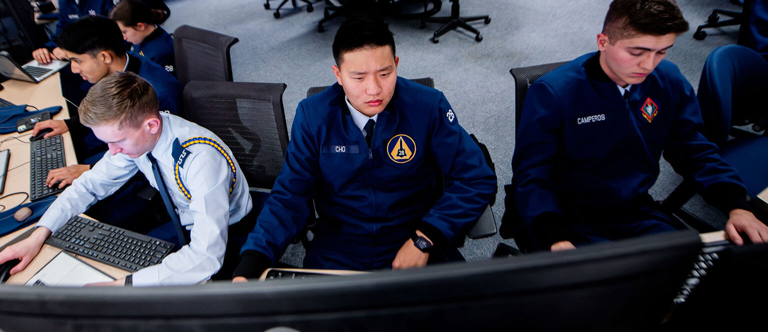 Cadets looking at data during a cyber challenge.