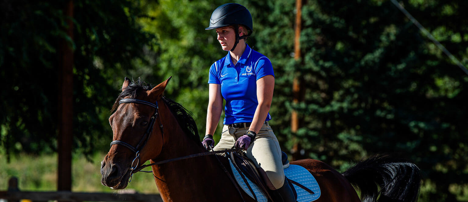 A cadet riding a horse as part of the Equestrian Club.