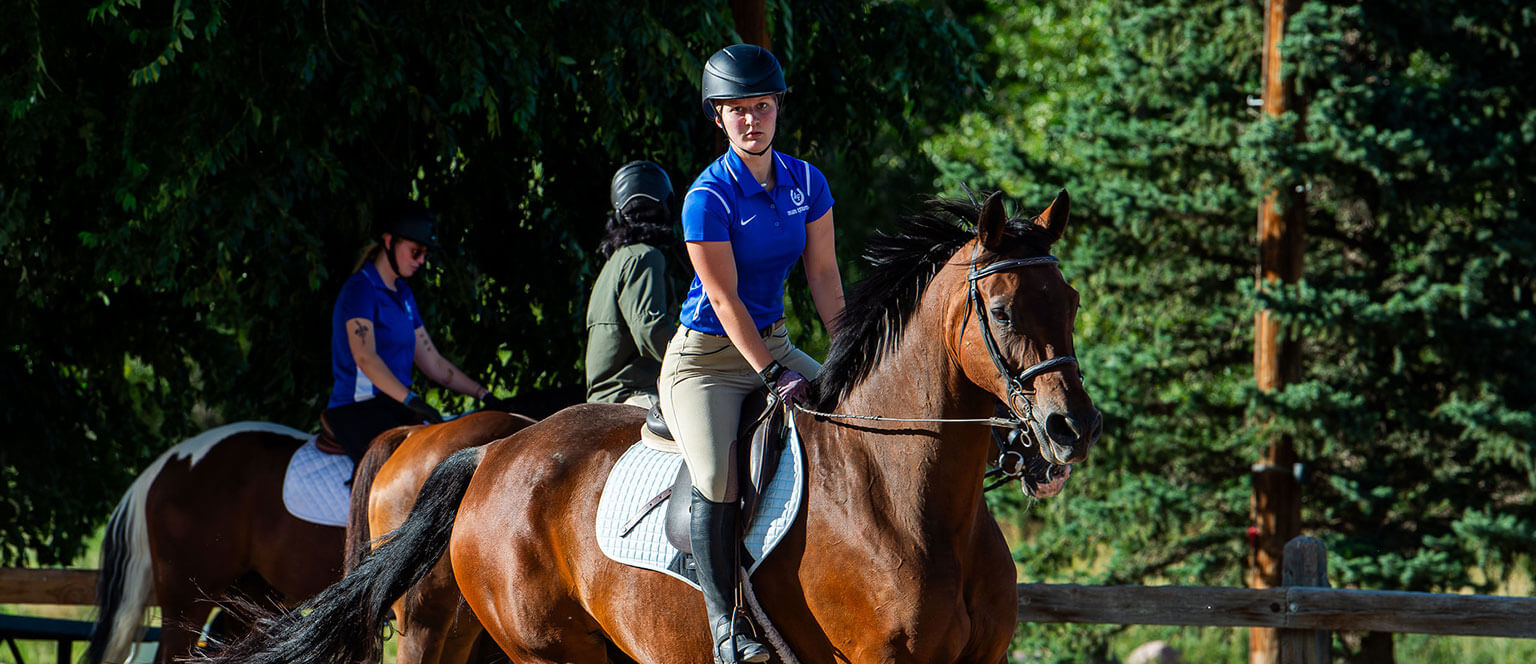 A cadet riding a horse as part of the Equestrian Club.