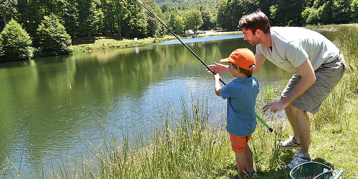 Parent teaching child to fish.
