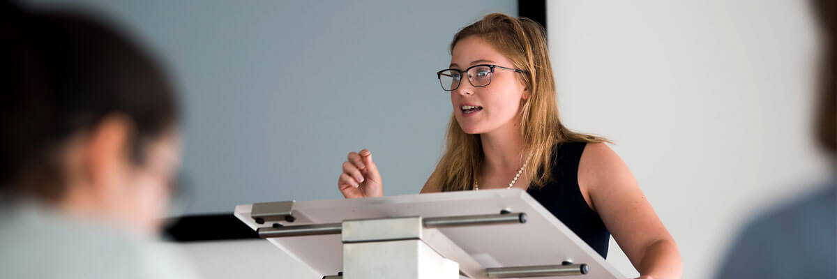 Image of a member of the Forensics Team making a speach.