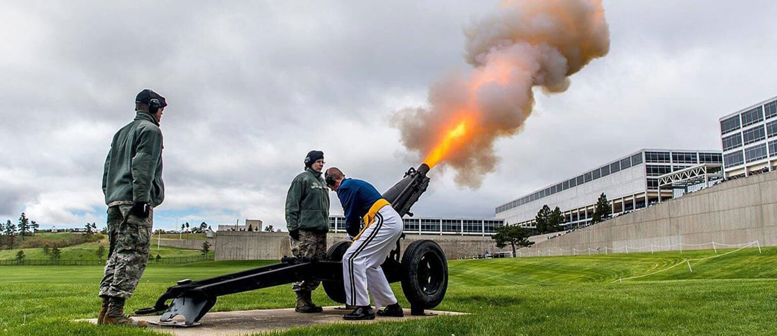Cadet Honor Guard firing a canon at the Graduation Parade.