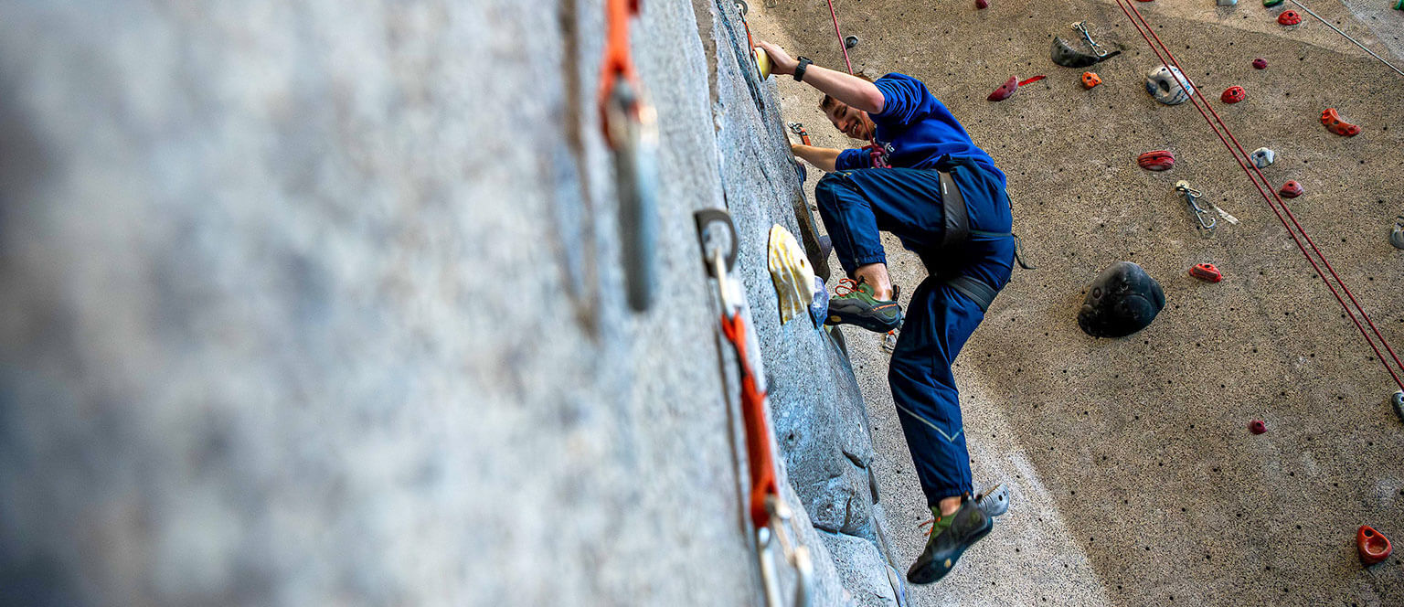 A Cadet in the Mountaineering Club using the climbing wall.