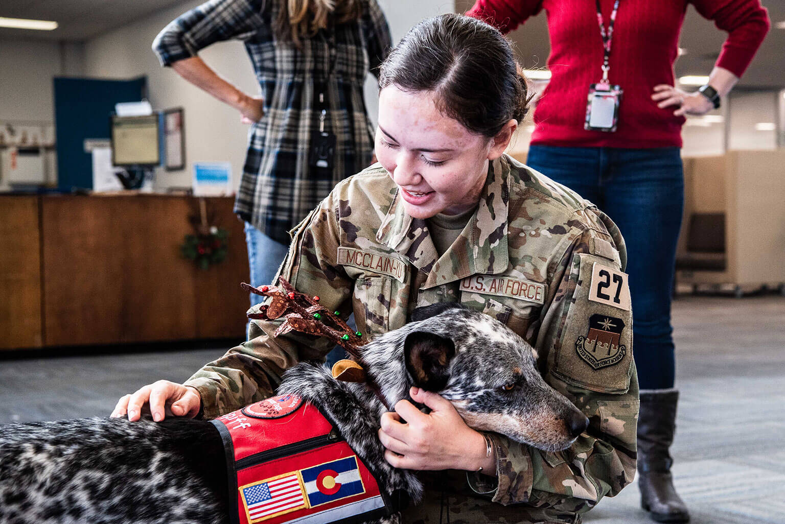 U.S. Air Force Academy Cadet 4th Class Eri McClain-Yu holds Go Team Therapy Crisis and Airport Dog Spiff in McDermott Library