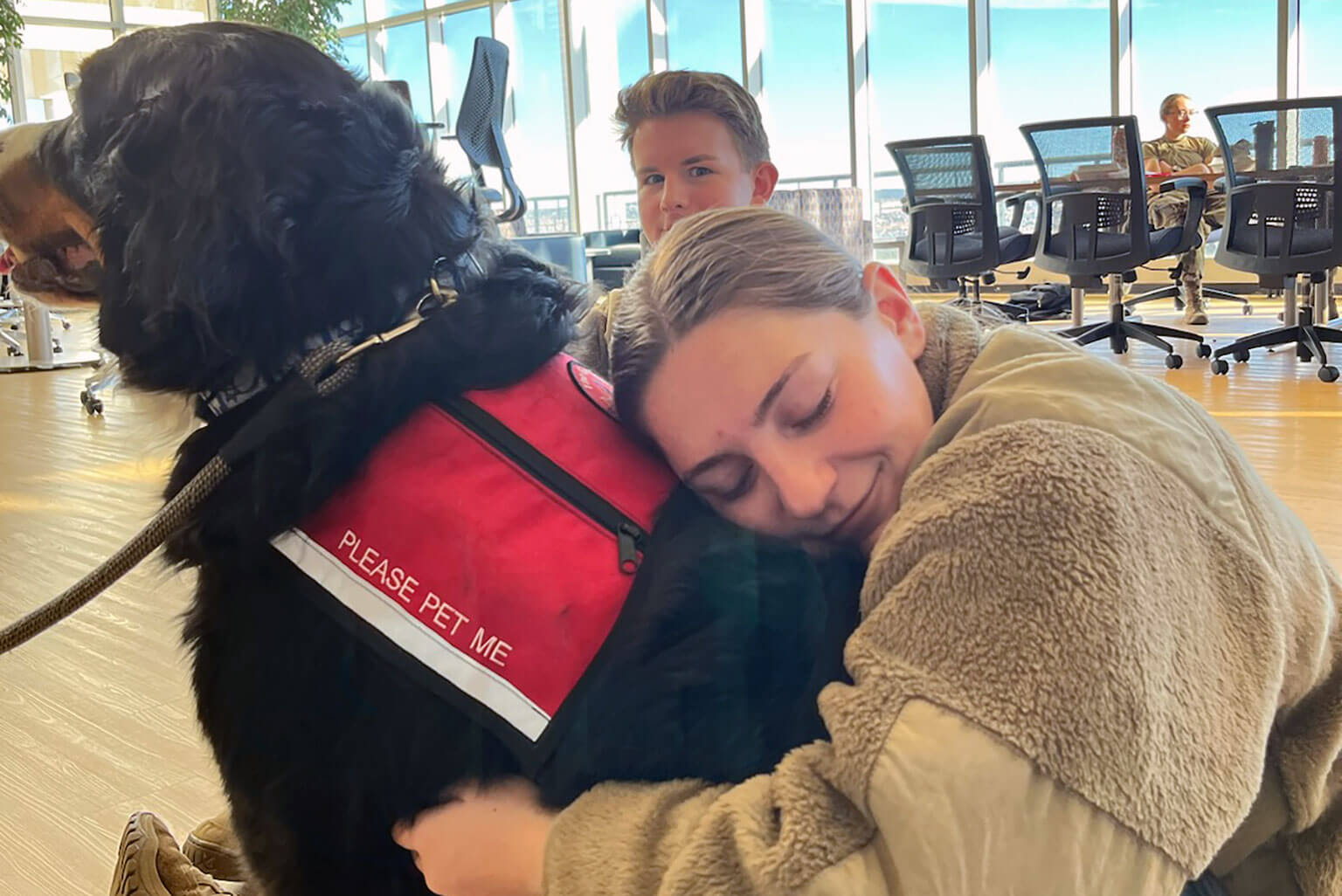 U.S. Air Force Academy Cadet 3rd Class Nicolina Brown hugs Go Team Therapy Crisis and Airport Dog Ace in McDermott Library Dec. 11, 2023. (Courtesy photo by Cadet 3rd Class Nicolina Brown) 