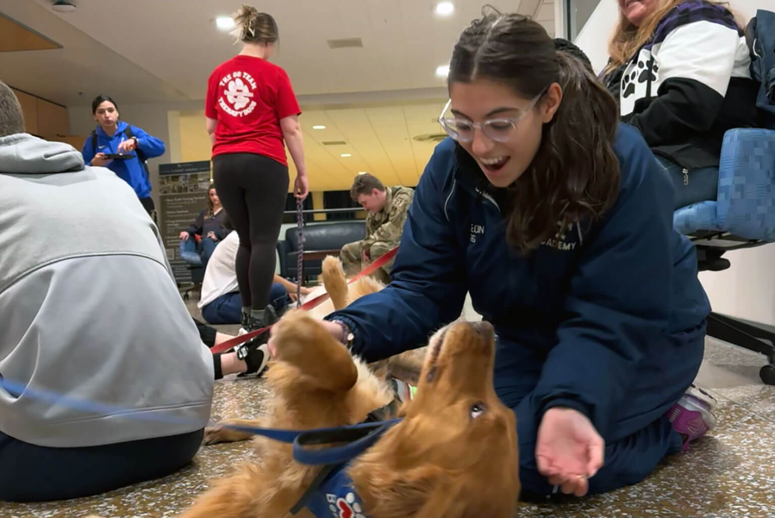 U.S. Air Force Academy Cadet 3rd Class Laura de Leon pets Go Team Therapy Crisis and Airport Dog Ben in Arnold Hall Jan. 25, 2024. (Courtesy photo by Cadet 3rd Class Laura de Leon)