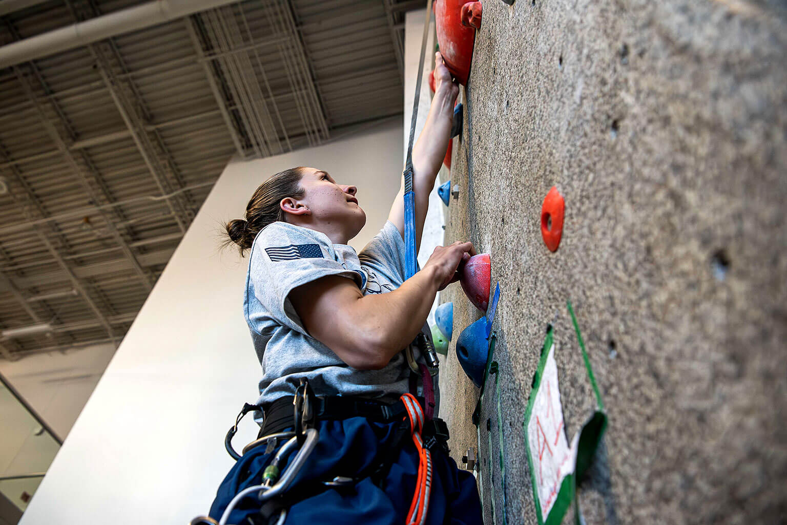 U.S. Air Force Academy Cadet 2nd Class Alyssa Hargis, one of the cadet Mountaineering Club, leaders, ascends the climbing wall in the Cadet Fitness Center.