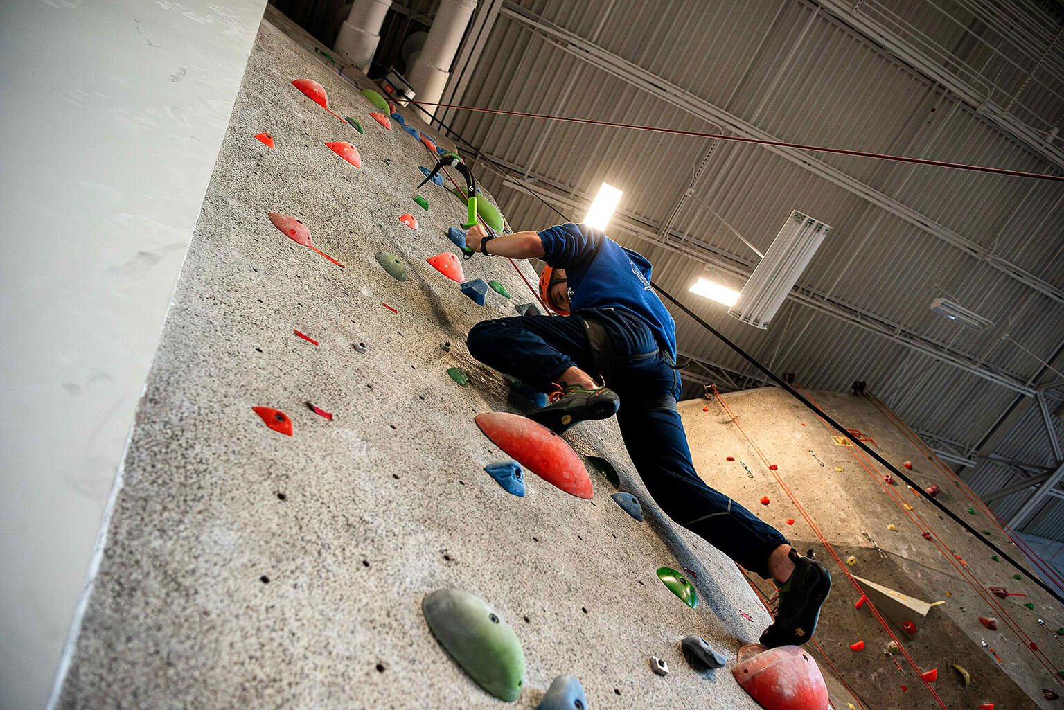 U.S. Air Force Academy Cadet 2nd Class Austin Curtis, a member of the cadet Mountaineering Club, ascends the climbing wall in the Cadet Fitness Center.