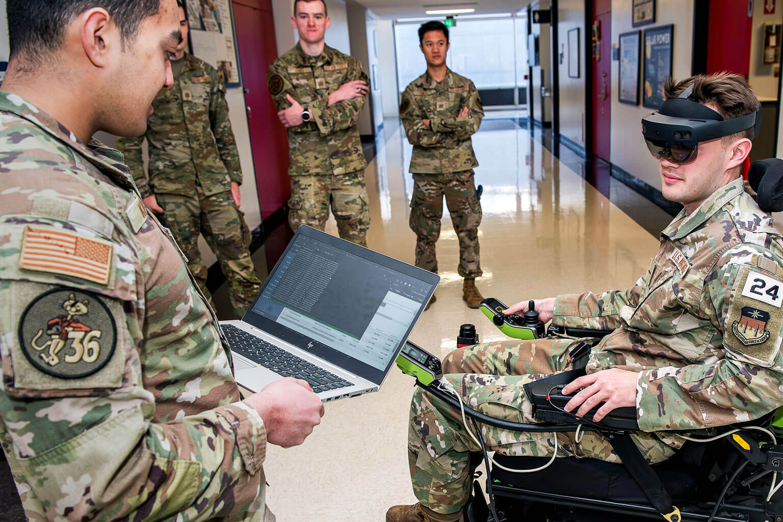 Department of Electrical and Computer Engineering Cadets 1st Class Ameen Khan, left, and Cade Isley, right, conduct the latest test of a gaze-assisted wheelchair, their assistive technology capstone project.