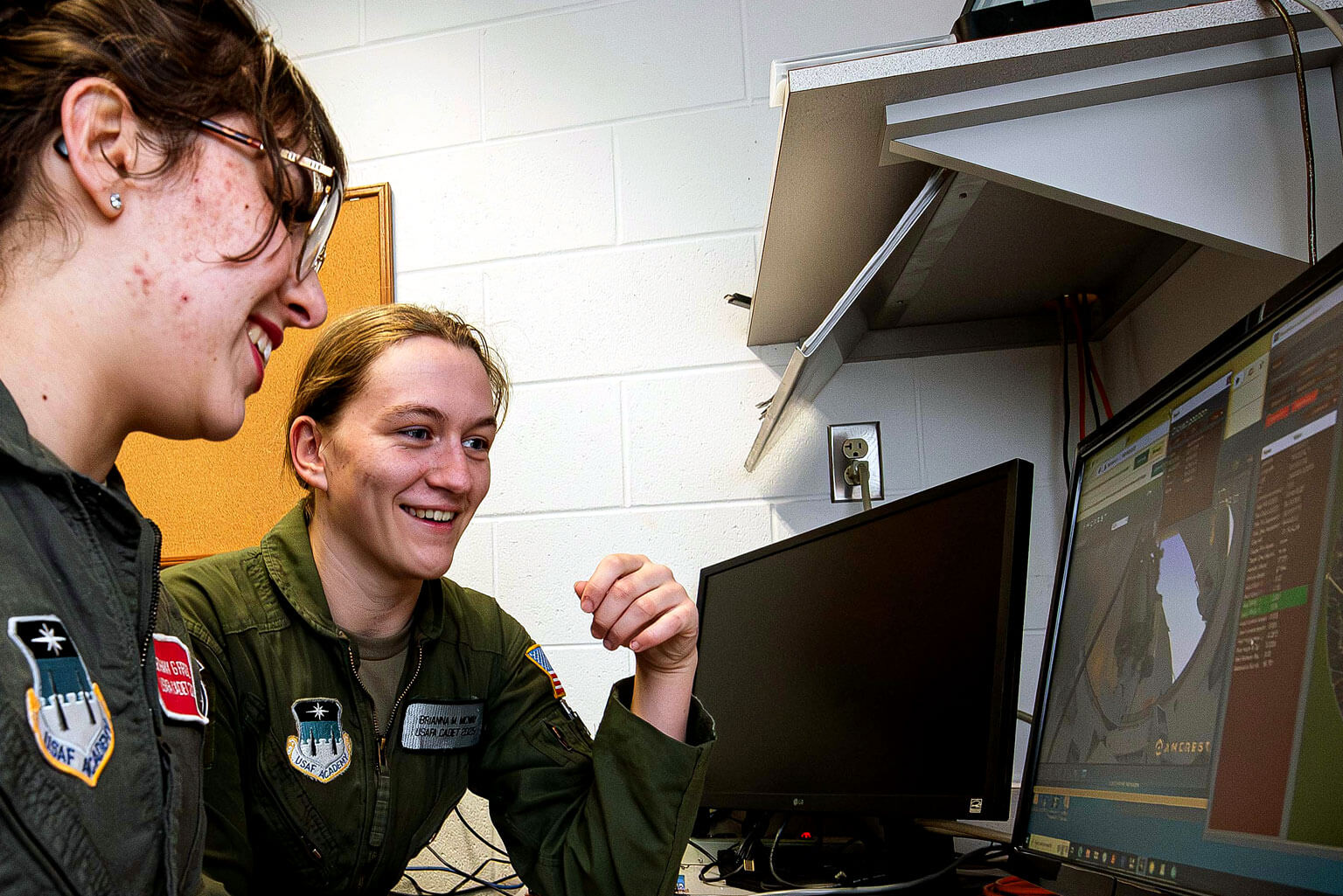 Cadet 3rd Class Bethany Firooz, left, and Cadet 2nd Class Brianna McVay control Department of Physics and Meteorology telescopes in the U.S. Air Force Academy Observatory.