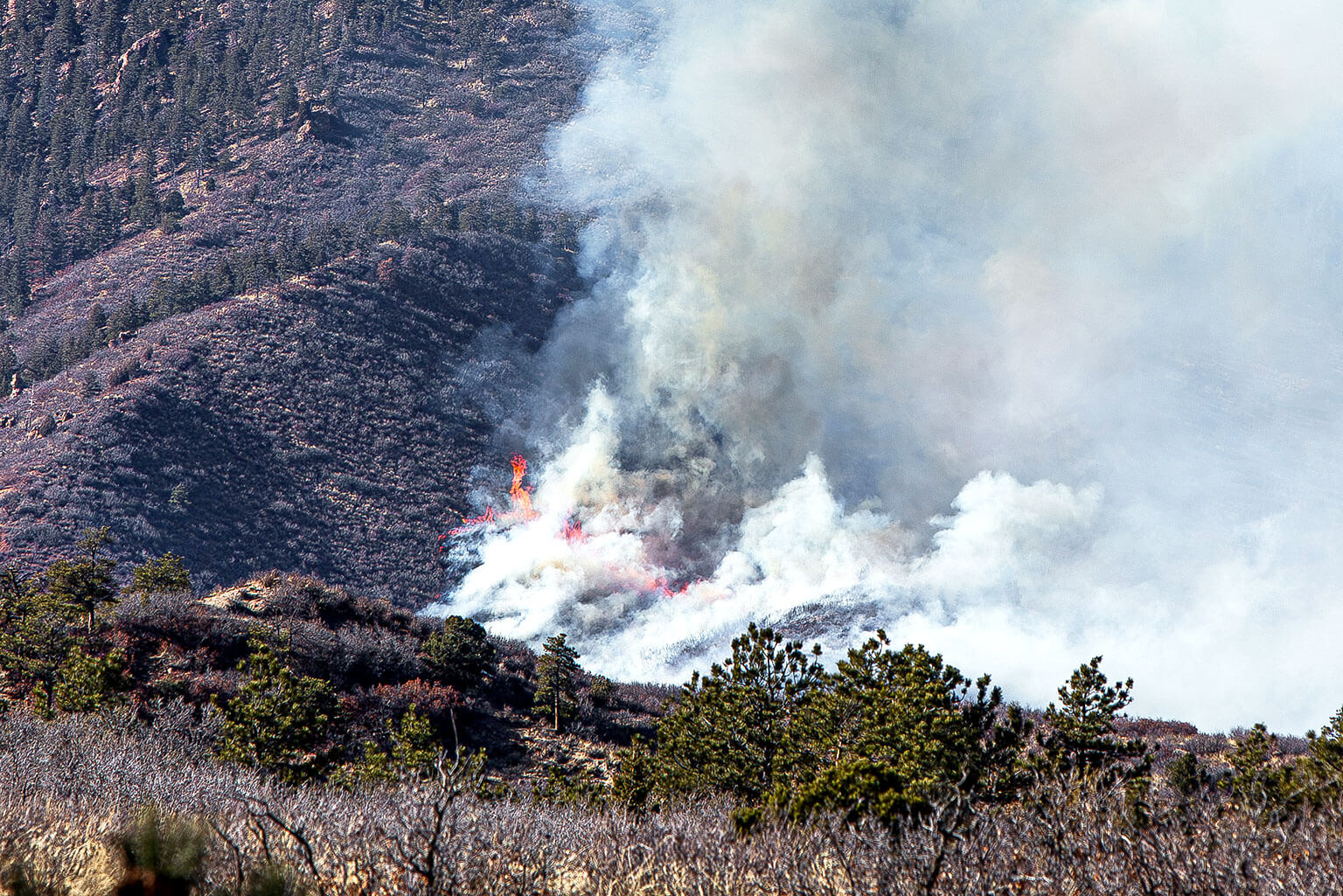 The West Monument Creek Fire started on the U.S. Air Force Academy Sunday, Feb. 25 and continues to burn Monday.