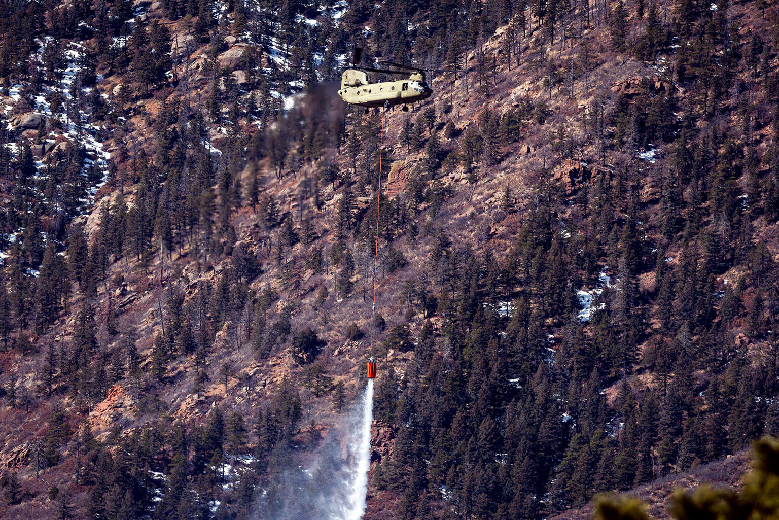 An Army CH-47 Chinook from Fort Carson, Colorado drops water on the West Monument Creek Fire.