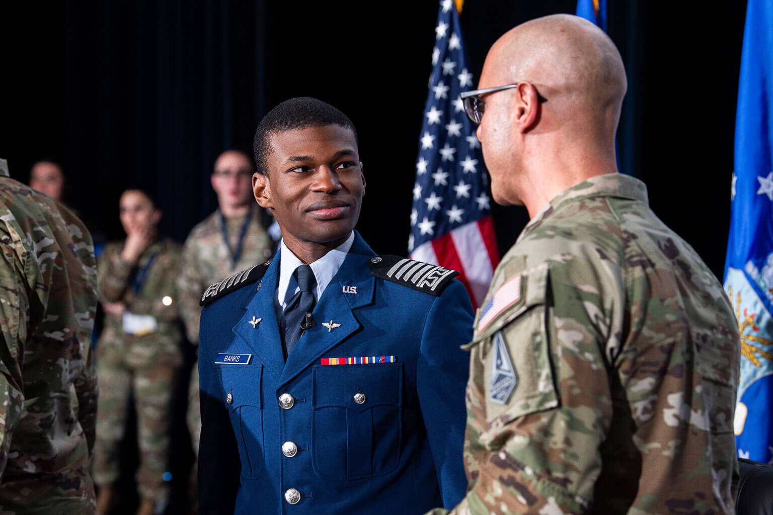 U.S. Air Force Academy Cadet 1st Class Ruben Banks speaks with Chief Master Sgt. Of the Space Force John Bentivegna.