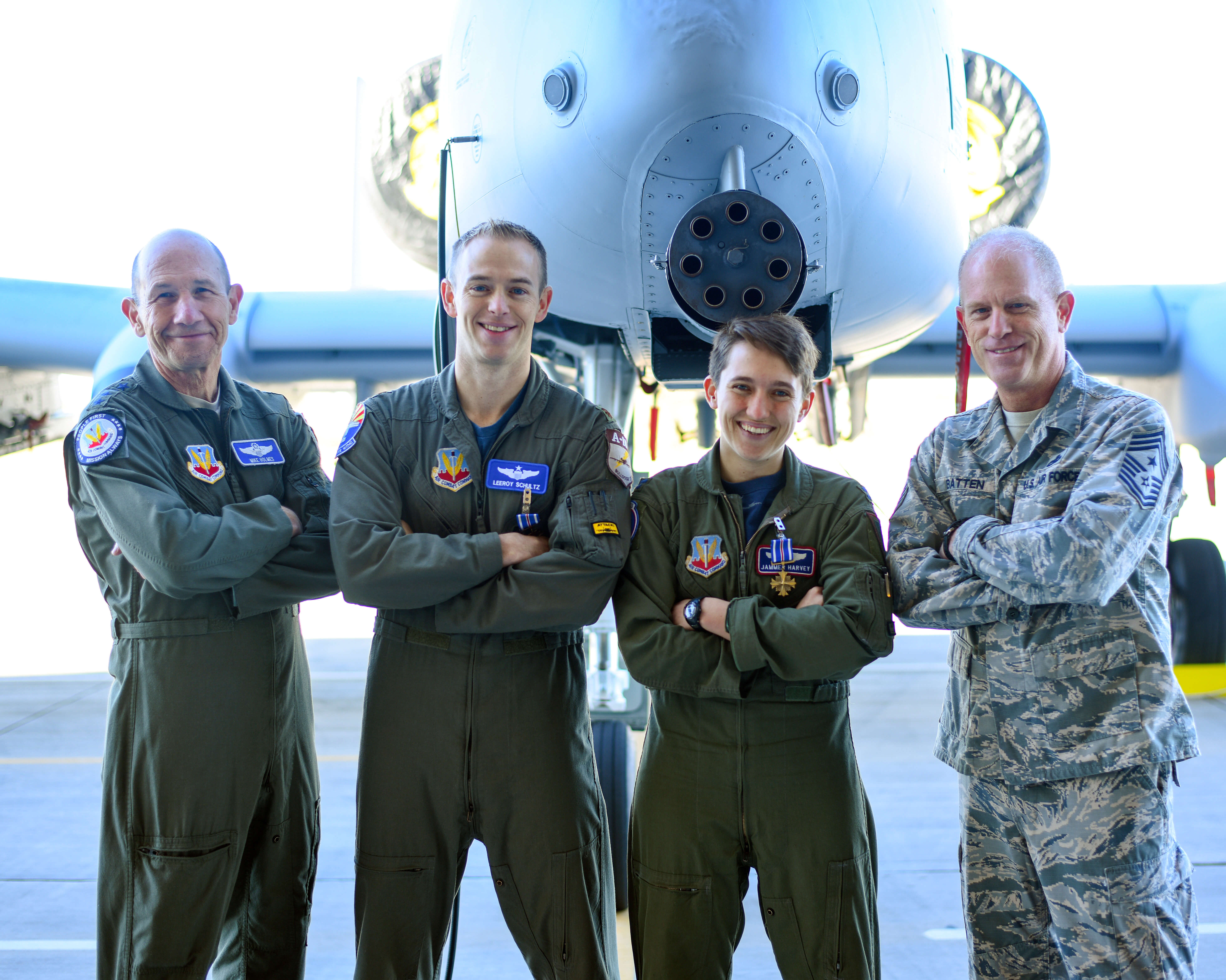 U.S. Air Force Gen. Mike Holmes, commander of Air Combat Command, Maj. Tyler Schultz and Capt. Samantha Harvey, 354th Fighter Squadron A-10C Thunderbolt II pilots, and Chief Master Sgt. Frank Batten III, command chief of ACC, pose for a photo at Davis-Monthan Air Force Base, Ariz