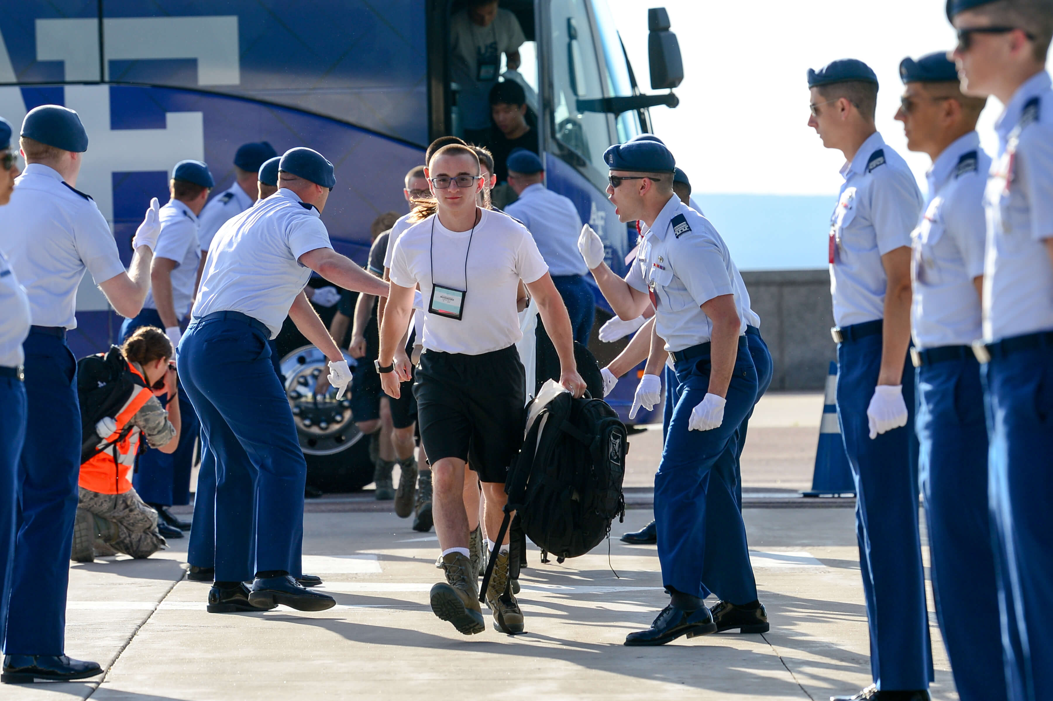 basic cadets walk off the bus at in-processing 