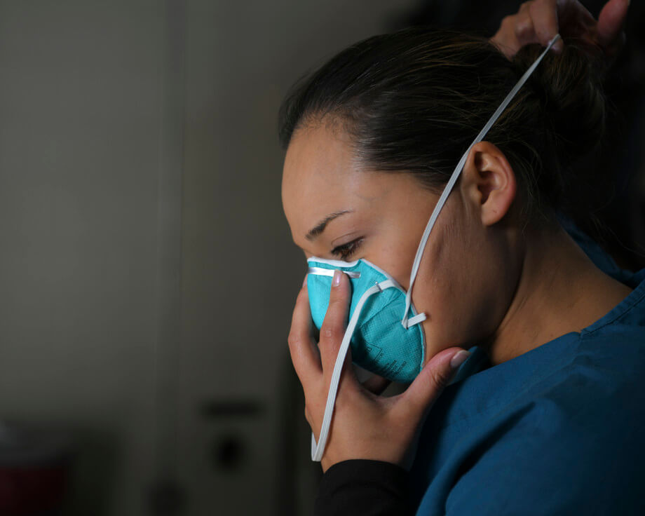 Person putting on face mask public health emergency