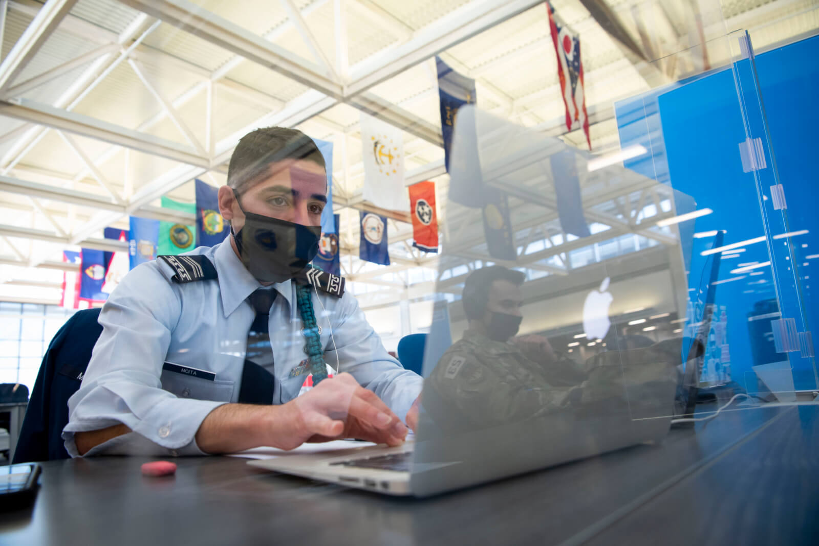 Cadet at laptop computer with Plexiglass shield