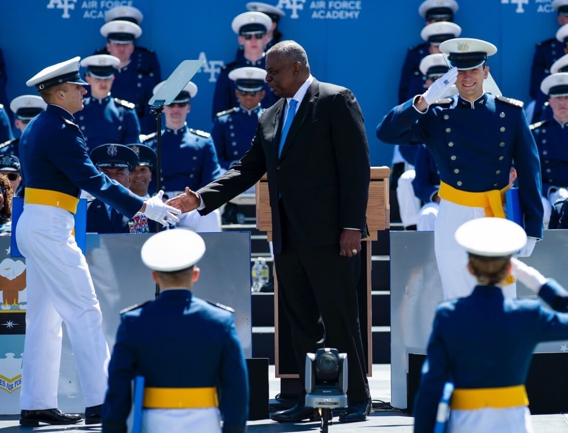 Secretary of Defense shakes hand with a cadet ay Graduation 