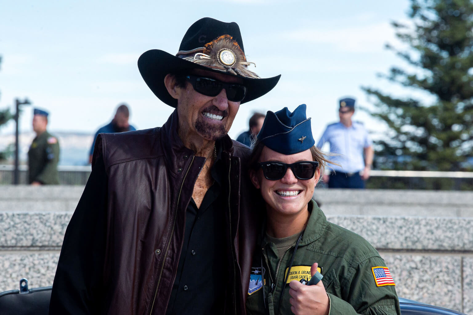 NASCAR Hall of Famer Richard Petty takes a photograph with a female cadet