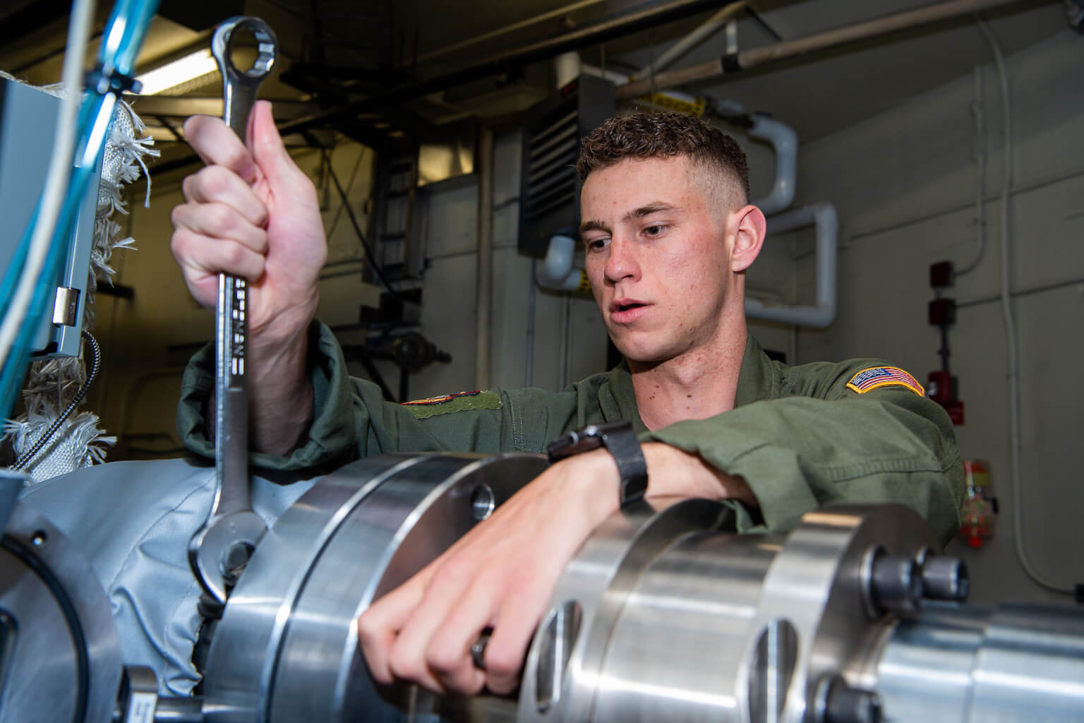 2nd Lt. Nicholas X. Hawley works on the combustion shock tube, on which he completed much of his experimental research.