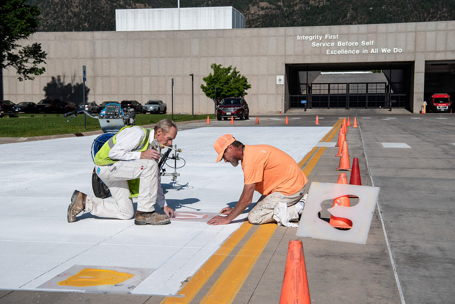 Workers painting gold footprints