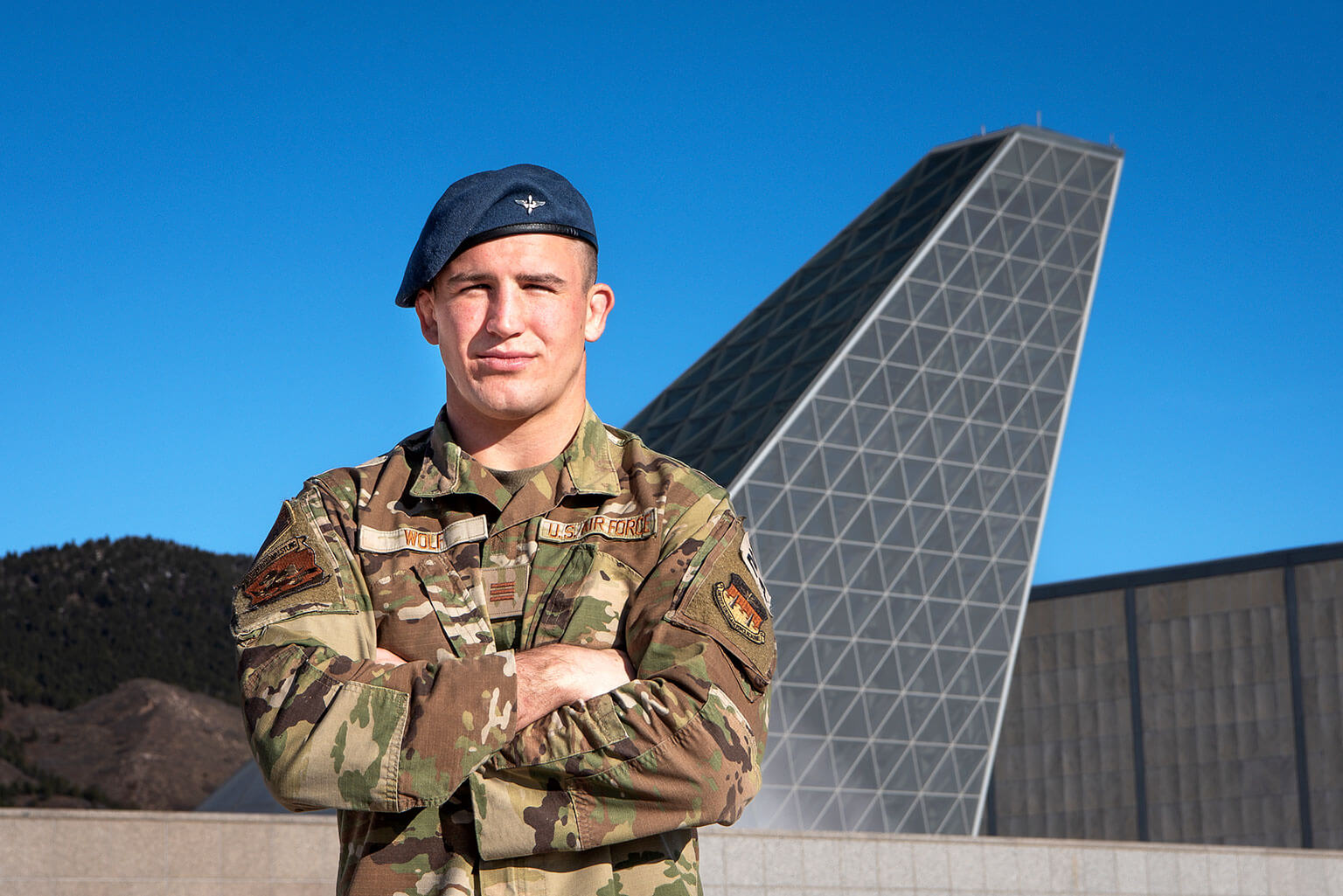 Cadet 1st Class Sam Wolf poses in front of Polaris Hall, the home of the U.S. Air Force Academy Center for Character and Leadership Development.