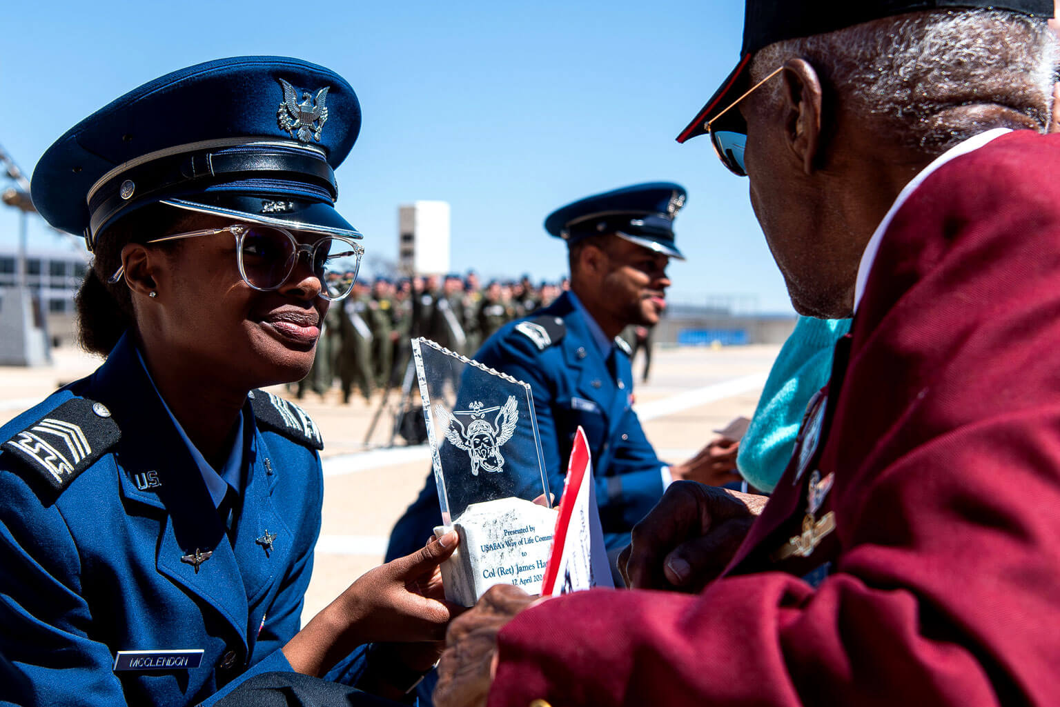 Cadet 2nd Class Jadoria McClendon presents a plaque from the Way of Life Committee to retired Col. James H. Harvey.