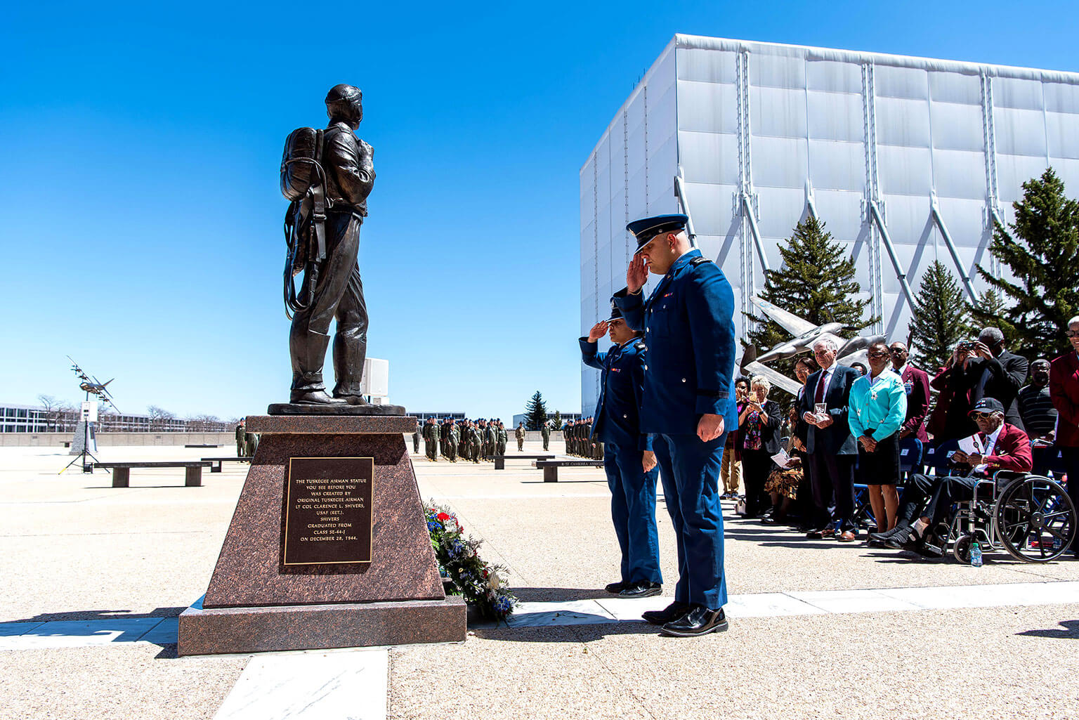 Cadets render salutes after they laid the wreath on the Tuskegee Airmen statue during a re-dedication and wreath-laying ceremony.