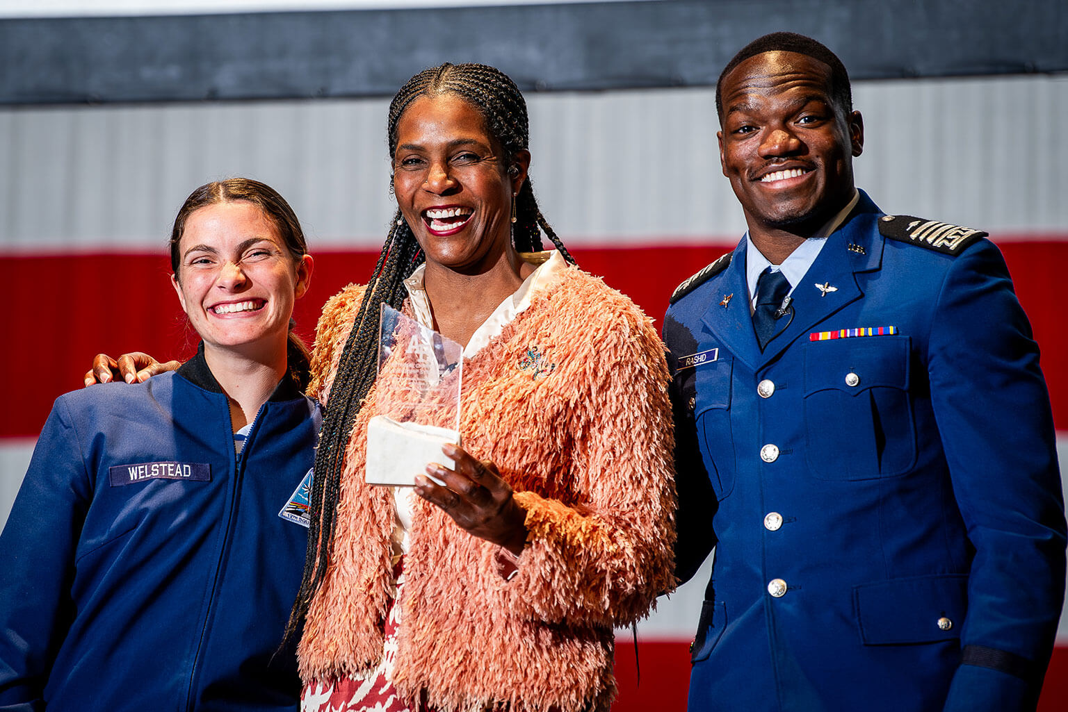 Cadet 2nd Class Samantha Welstead, left, Wounded Warrior Project’s Warriors Speak spokesperson Tonya Oxendine, and Cadet 1st Class Nasir Rashid pose for a photo after the National Character and Leadership Symposium Bridge Event in Arnold Hall Theater.