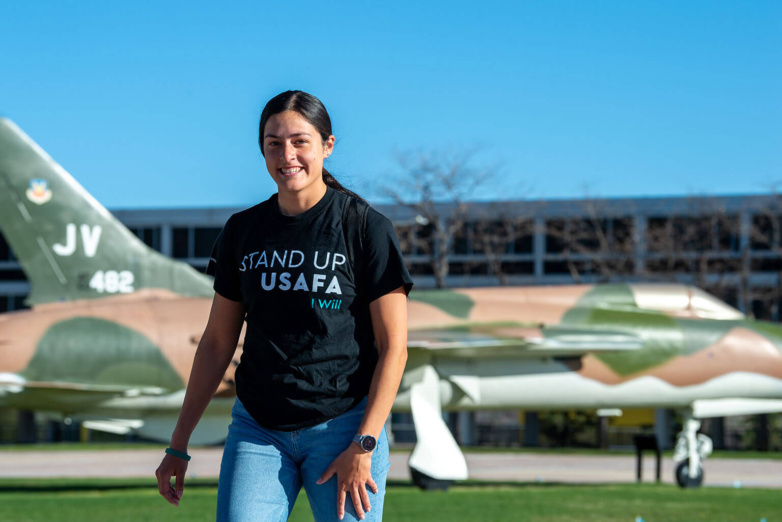 A cadet wearing her “Stand Up USAFA” T-shirt walks across the Terrazzo between classes.
