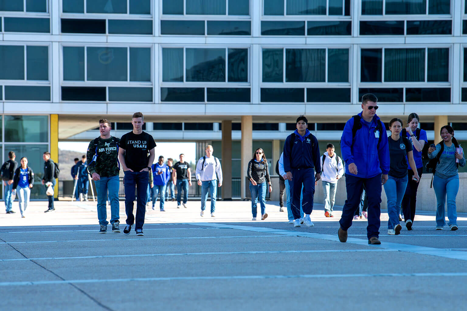 Cadets clad in denim and spirit wear walk on the Terrazzo between classes.