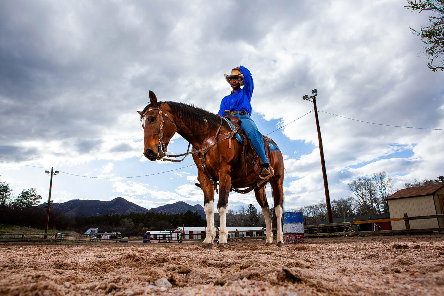 Cadet 3rd Class Lauryn Mitchell sits on the U.S. Air Force Academy Rodeo Club horse, Rebel, in the arena.