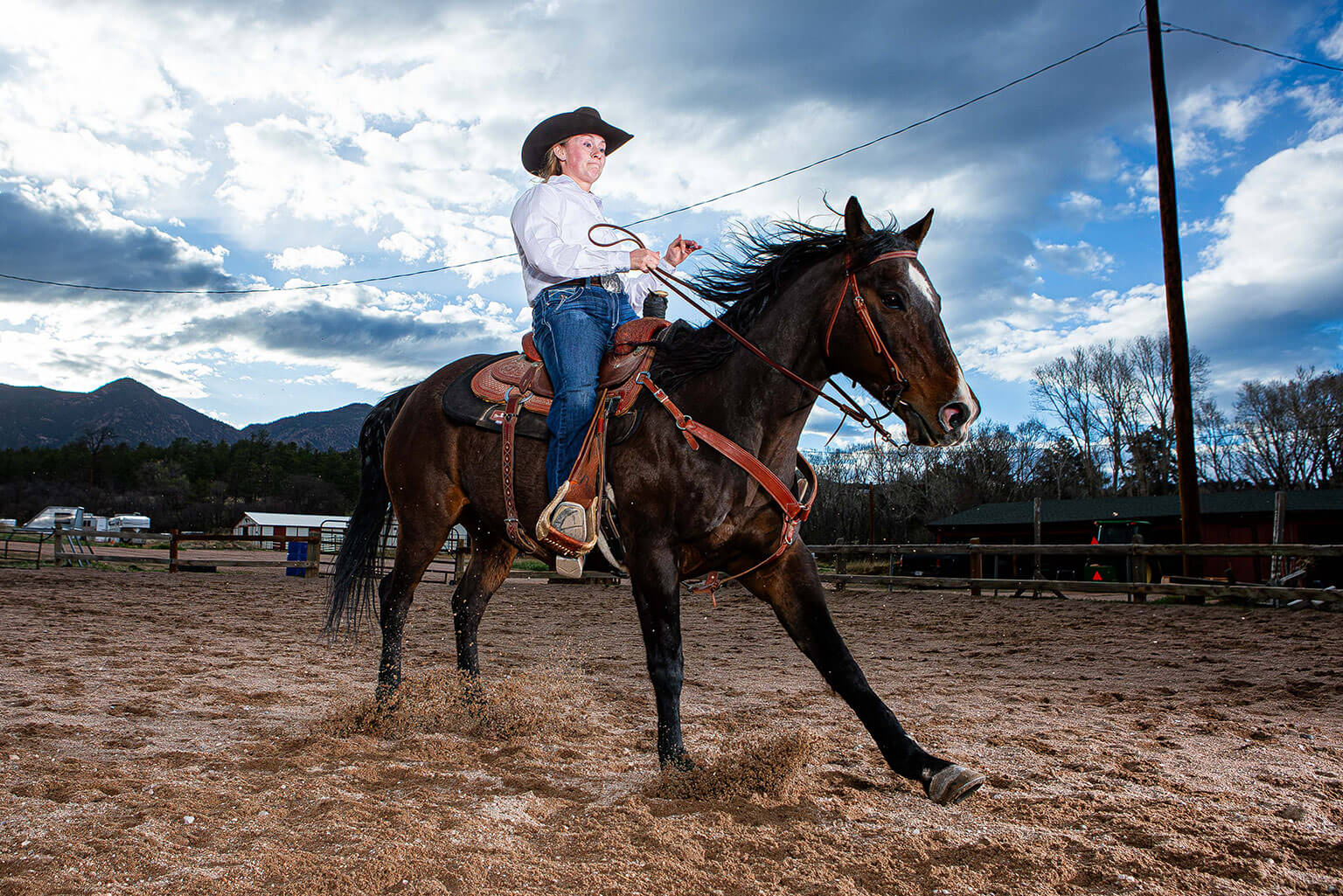 Cadet 2nd Class Colette McClanahan brings her horse, Bear, to a stop in the U.S. Air Force Academy Rodeo Club arena.