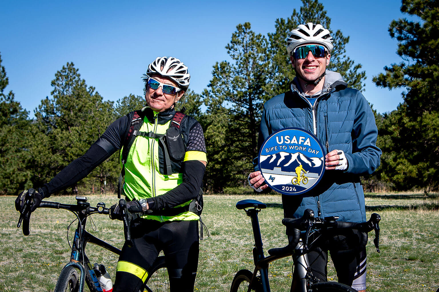 Cadet 1st Class Sean Maison displays the U.S. Air Force Academy 2024 Bike to Work plaque before bicyclists left Falcon Stadium.