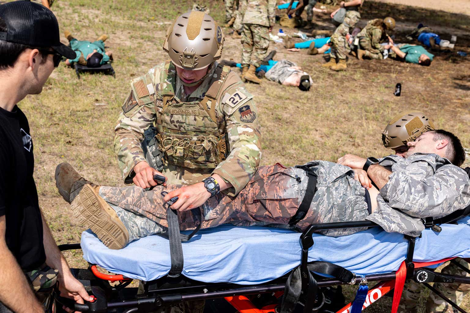 A U.S. Army Soldier from Charlie Company, 3rd Battalion, 10th Special Forces Group, observes U.S. Air Force Academy Cadet 2nd Class Tristan Schemmerling’s response to a simulated mass-casualty event.