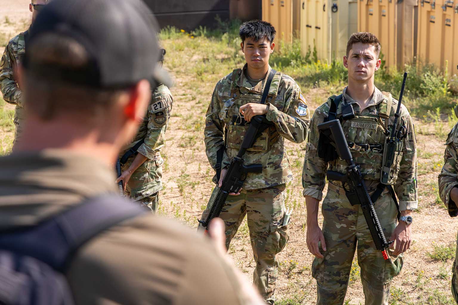 A U.S. Army Soldier from Charlie Company, 3rd Battalion, 10th Special Forces Group, instructs Cadet 1st Class Neo Takazawa and Cadet 2nd Class Henry Rasmussen on small-unit tactics during the Cadet Warfighter Instructor Course.