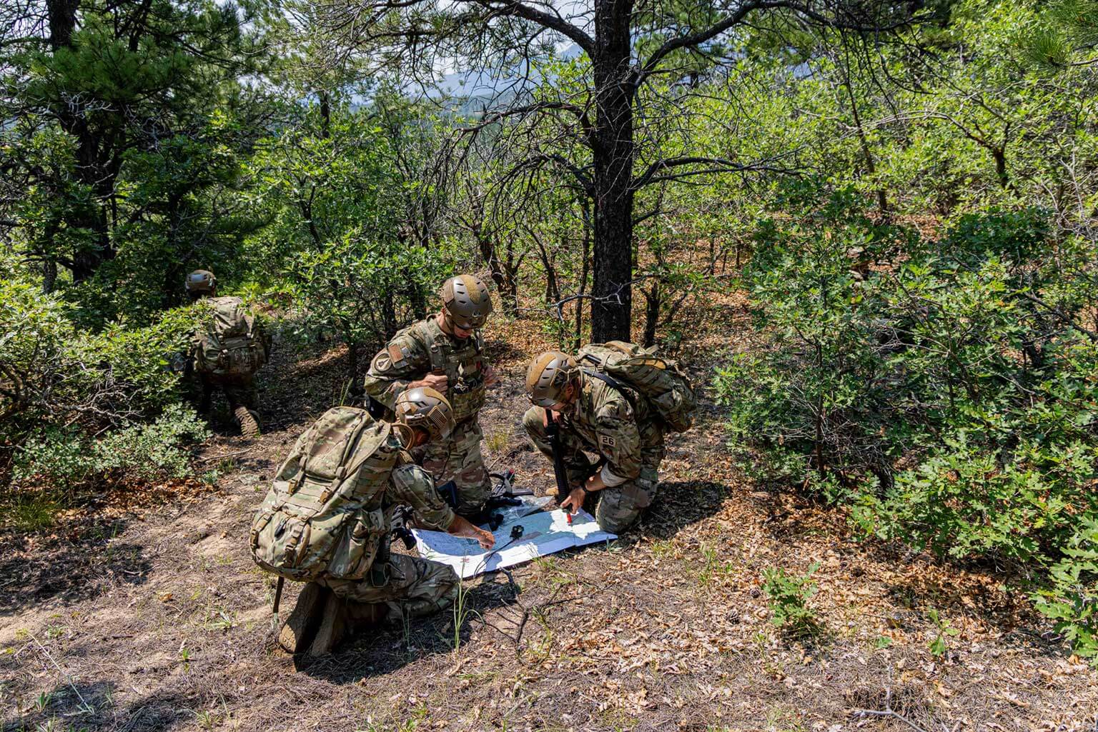 U.S. Air Force Academy upper-class cadets conduct a map reconnaissance of a potential ambush site during the Cadet Warfighter Instructor Course.
