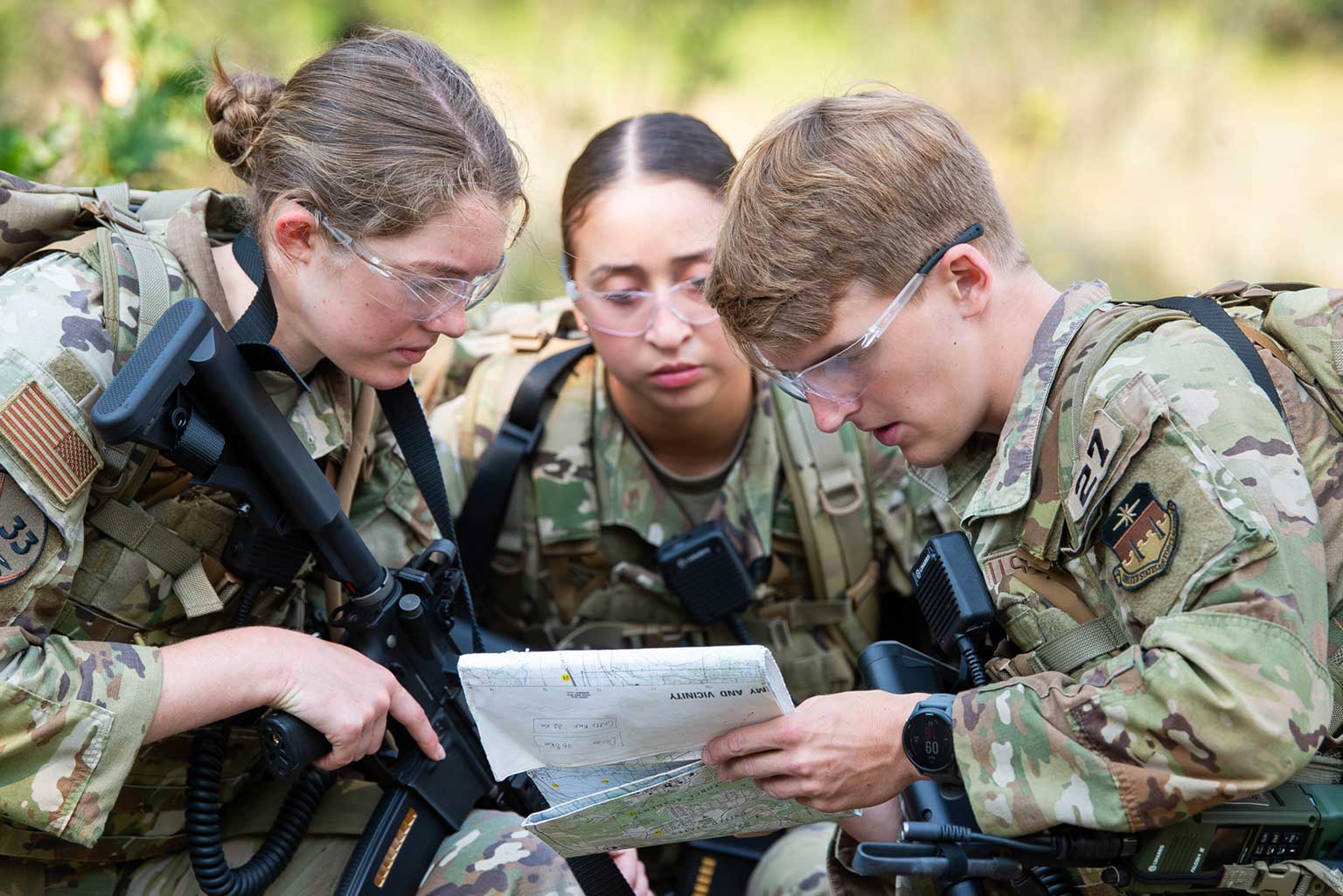 Cadet 2nd Class Micaela Martz, Cadet 1st Class Alejandra Tirado-Elias, and Cadet 2nd Class Derek Weissinger conduct a map reconnaissance during the Cadet Warfighter Instructor Course.