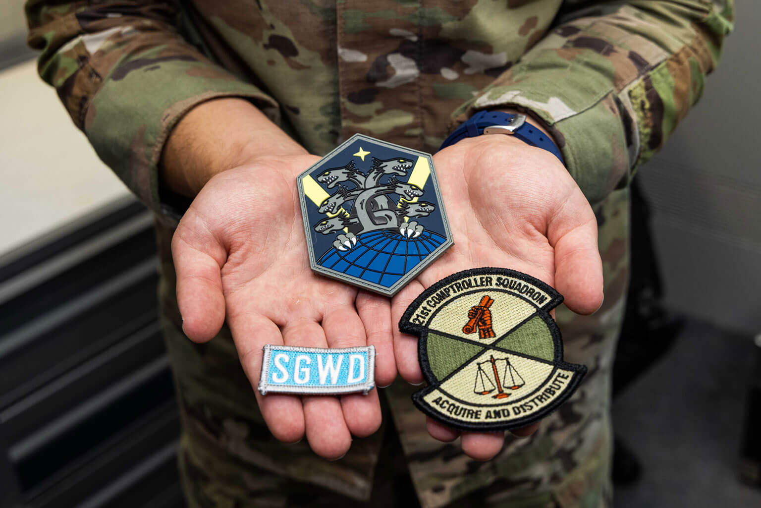Then-Cadet Candidate Roman Bereguta holds patches with personal significance to him at the U.S. Air Force Academy Preparatory School, Colo., Aug. 26, 2025. His path to the Prep School included enlisted service as a financial technician and a deployment with Task Force Grey Wolf, where he used his Ukrainian and Russian language skills. (U.S. Air Force photo by Trevor Cokley)