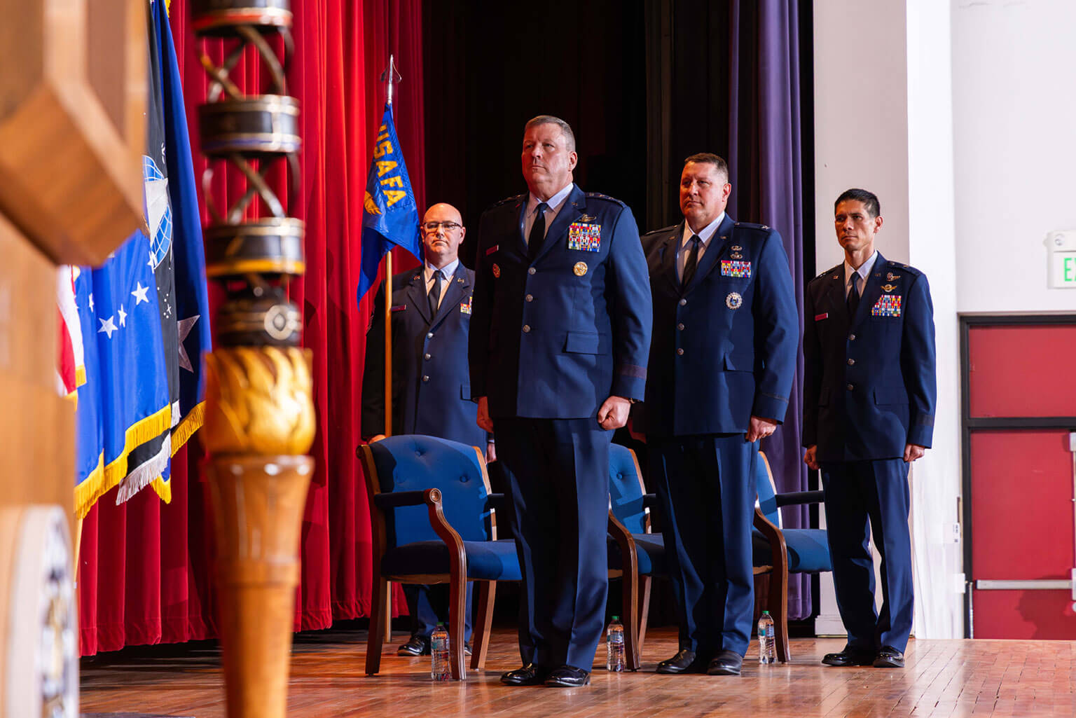 Chief Master Sgt. Micheal Dederich (left to right), Lt. Gen. Tony Bauernfeind, Col. Steven C. M. Hasstedt, and Brig. Gen. James M. Valpiani stand at attention during the playing of the The Star-Spangled Banner at the U.S. Air Force Academy’s dean of the faculty change of command, here March 16, 2025. During the ceremony Brig. Gen. Valpiani became the Academy’s 12th Dean of the Faculty after taking command from Col. Hasstedt. Photo by Trevor Cokely.