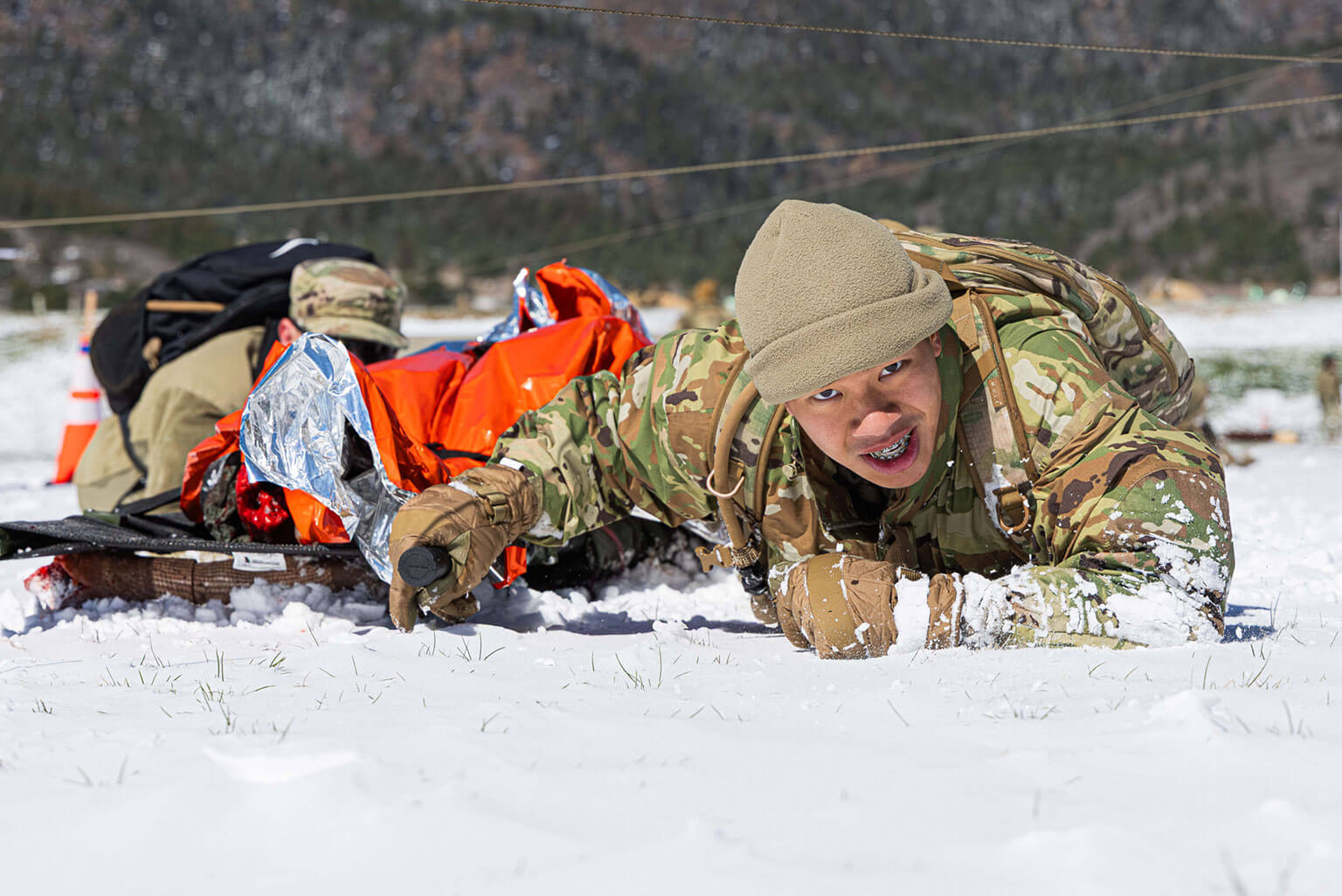 A cadet performs a low crawl after assessing and treating a manikin patient during the Superintendent’s Challenge as part of the Spring Culminating Exercise (CULEX) at the U.S. Air Force Academy, Colo., April 18, 2026. CULEX equipped cadets with a broad range of leadership skills and experience to ensure they are ready to lead on Day One. (U.S. Air Force photo by Trevor Cokley)