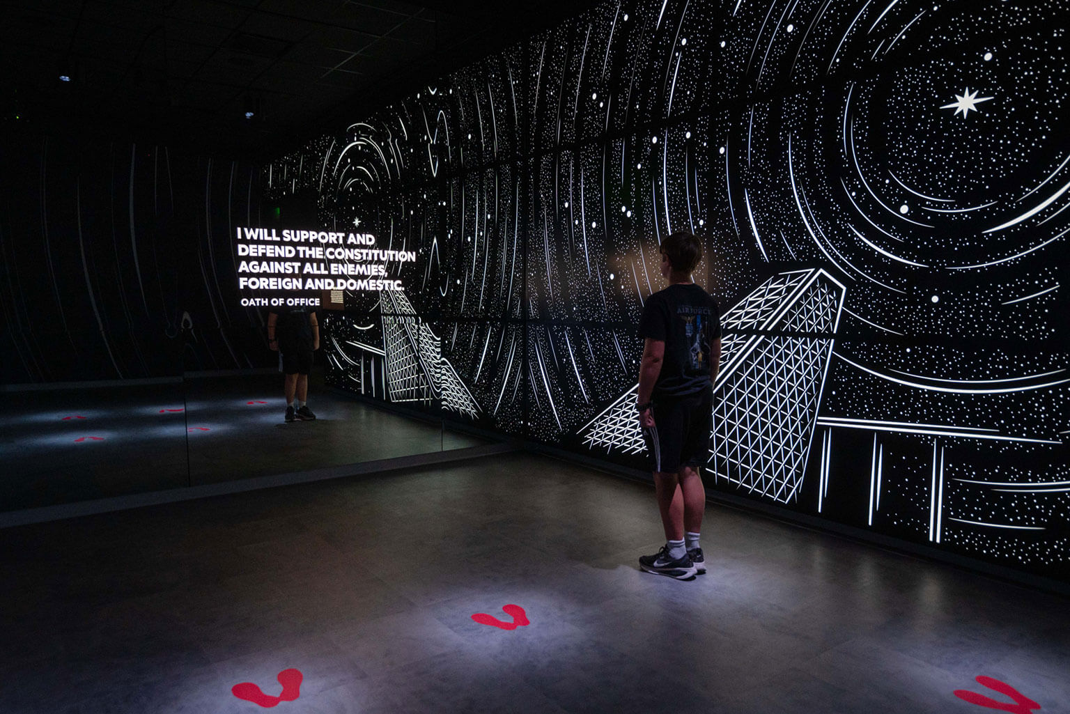 David Goddard, a 13-year-old resident of Colorado Springs and grand opening attendee, steps on footprints during the Hosmer Visitor Center grand opening, U.S. Air Force Academy, Colo., May 16, 2026. Attendees explored interactive galleries and digital exhibits that reflect key moments throughout a cadet’s time at the Academy. (U.S. Air Force photo by Tech. Sgt. Zach Vaughn)