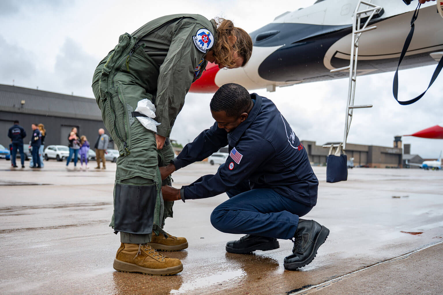 Taylor Lorbiecki, a U.S. Air Force Academy assistant strength and conditioning coach, puts on flight gear prior to her orientation flight with the U.S. Air Force Thunderbirds at Peterson Space Force Base, Colorado, May 27, 2026. The flight honored Lorbiecki, the Academy’s Academic Year 2025-2026 Civilian Instructor of the Semester, whose work supports cadets across the Academy. She led the development of the Academy's Rated Physical Readiness capstone course to build the mental, physical, nutritional, and recovery capabilities required for rated assignments. (U.S. Air Force photo by Tiana Williams)