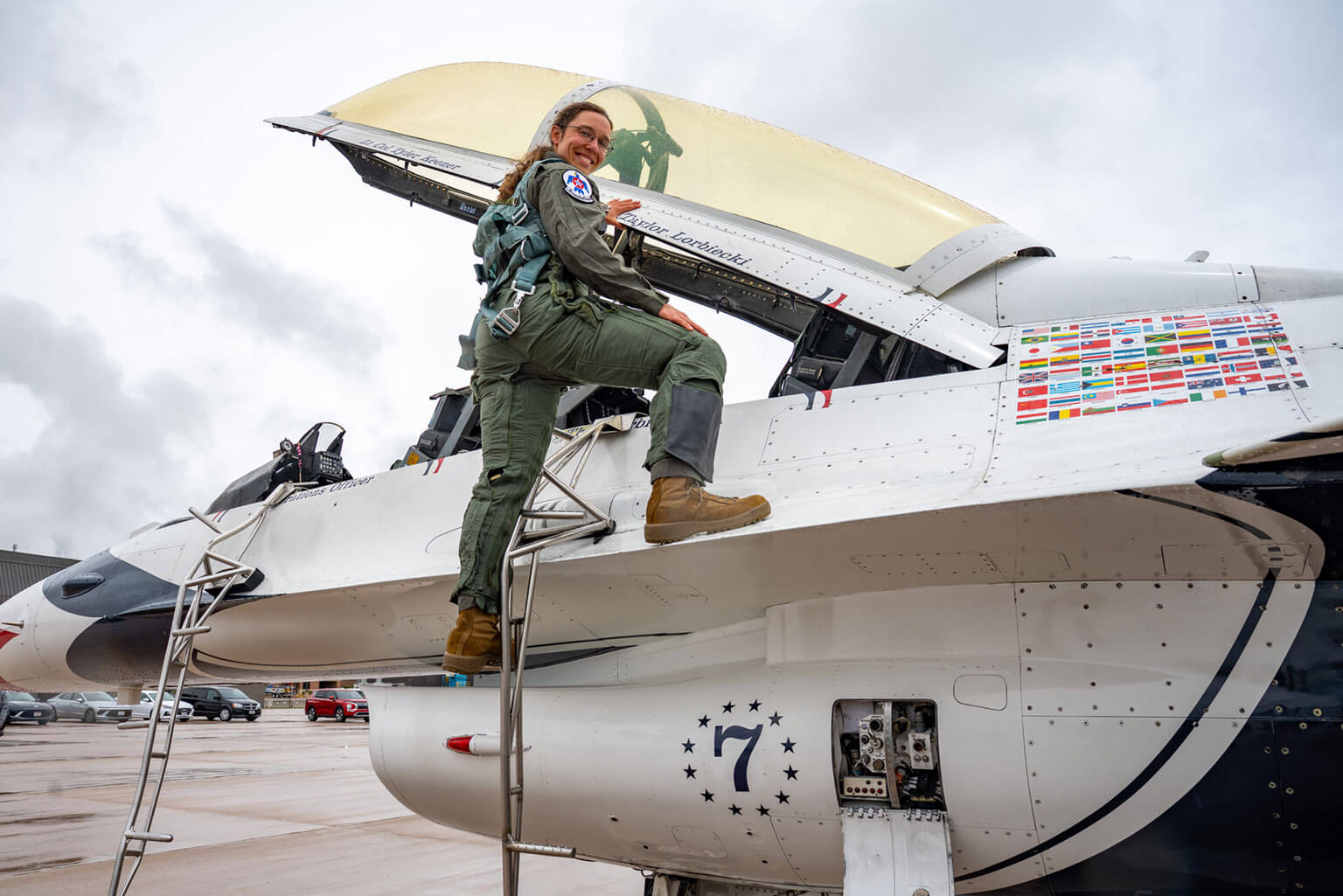 Taylor Lorbiecki, a U.S. Air Force Academy assistant strength and conditioning coach, poses for a photo on an F-16 Fighting Falcon at Peterson Space Force Base, Colorado, May 27, 2026. Over the past few years, Lorbiecki led the development of the Academy’s Rated Physical Readiness capstone course and modernized conditioning programs across the cadet wing, contributing to a 76.5 percent reduction in bone stress injuries during Basic Cadet Training. (U.S. Air Force photo by Tiana Williams)