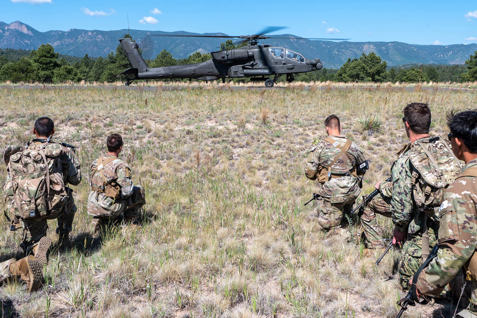 Cadets observe a U.S. Army AH-64 Apache helicopter during a Special Warfare Orientation Course (SWOC) full mission profile at the U.S. Air Force Academy, Colo., June 15, 2026. During SWOC’s second week, Academy and ROTC cadets participated in full mission profiles to gain insight into the preparation and execution of missions within Air Force Special Warfare career fields. (U.S. Air Force photo by Jonathan Suni)