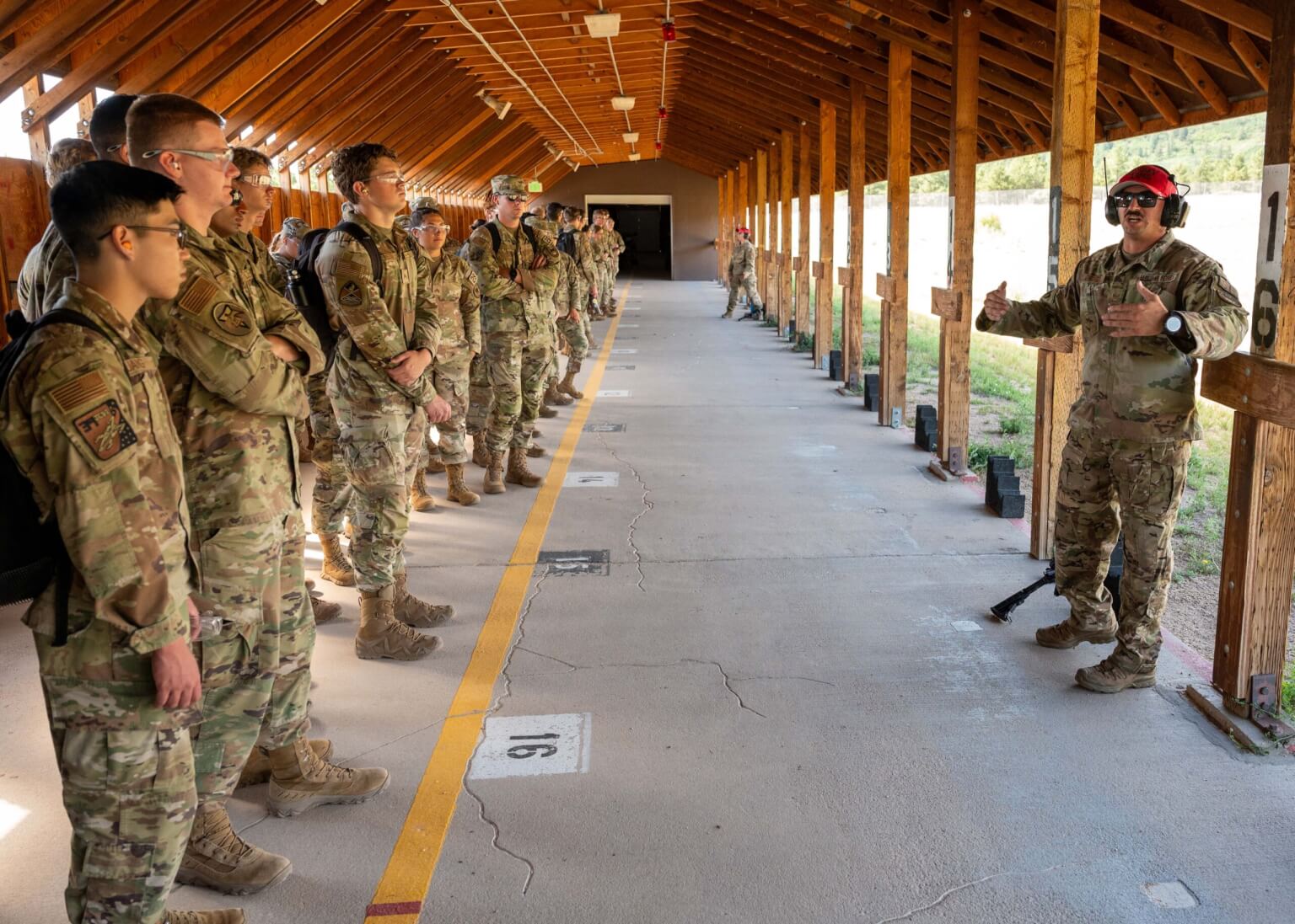 Tech. Sgt. Matthew Gardner (right), 10th Security Forces Squadron, Combat Arms Training and Maintenance (CATM) Instructor, teaches Cadet Warfighter Instructor’s Course (CWIC)participants how to operate a CATM line and sight an optic during a CWIC practical application session, at the U.S. Air Force Academy, Colo, July 29, 2026. CWIC participants learn tactical level techniques and procedures and how to apply them at the operational level using command and control principles. (U.S. Air Force photo by Tech. Sgt. Zach Vaughn)